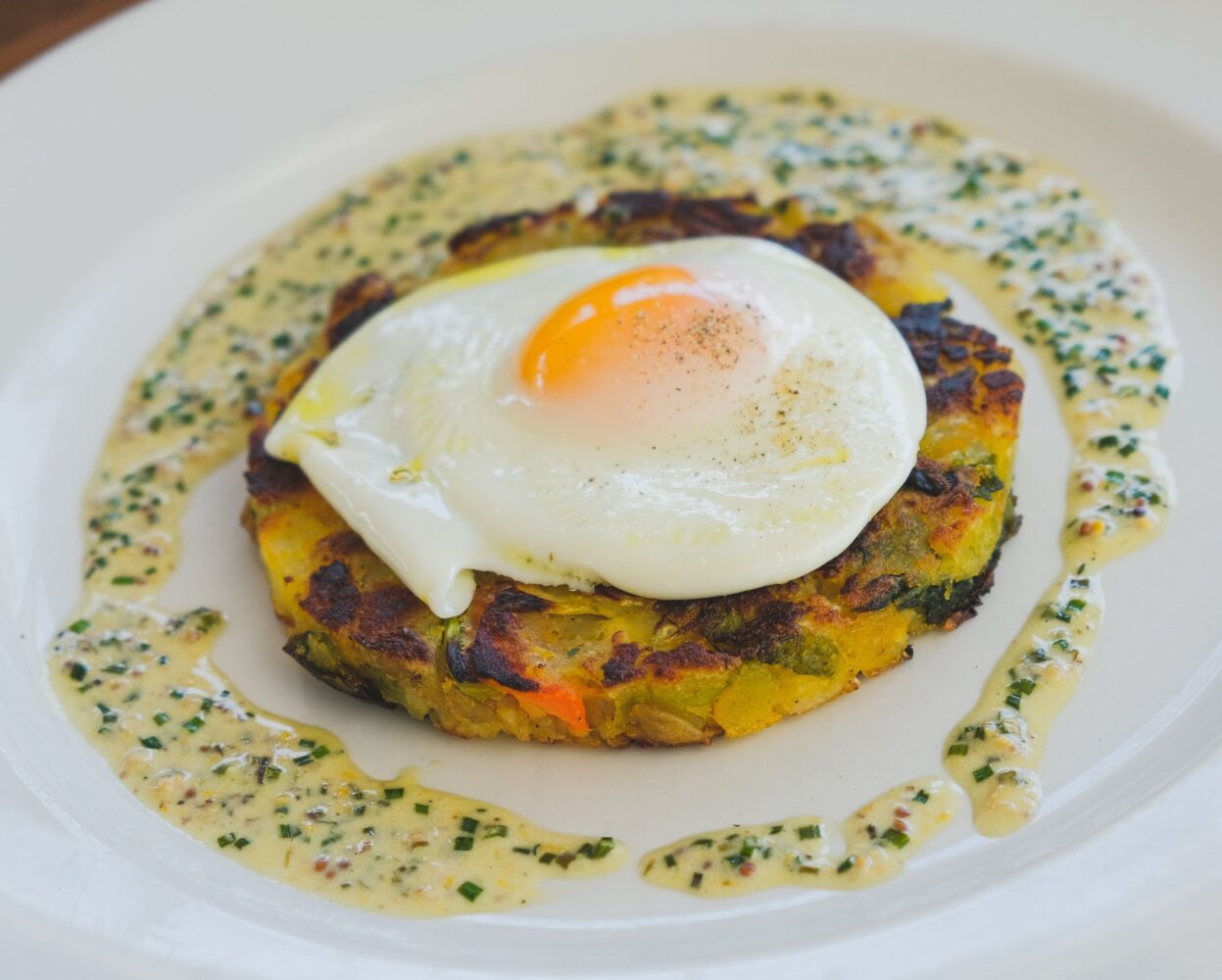 Bubble and squeak with fried hen's egg and mustard cream